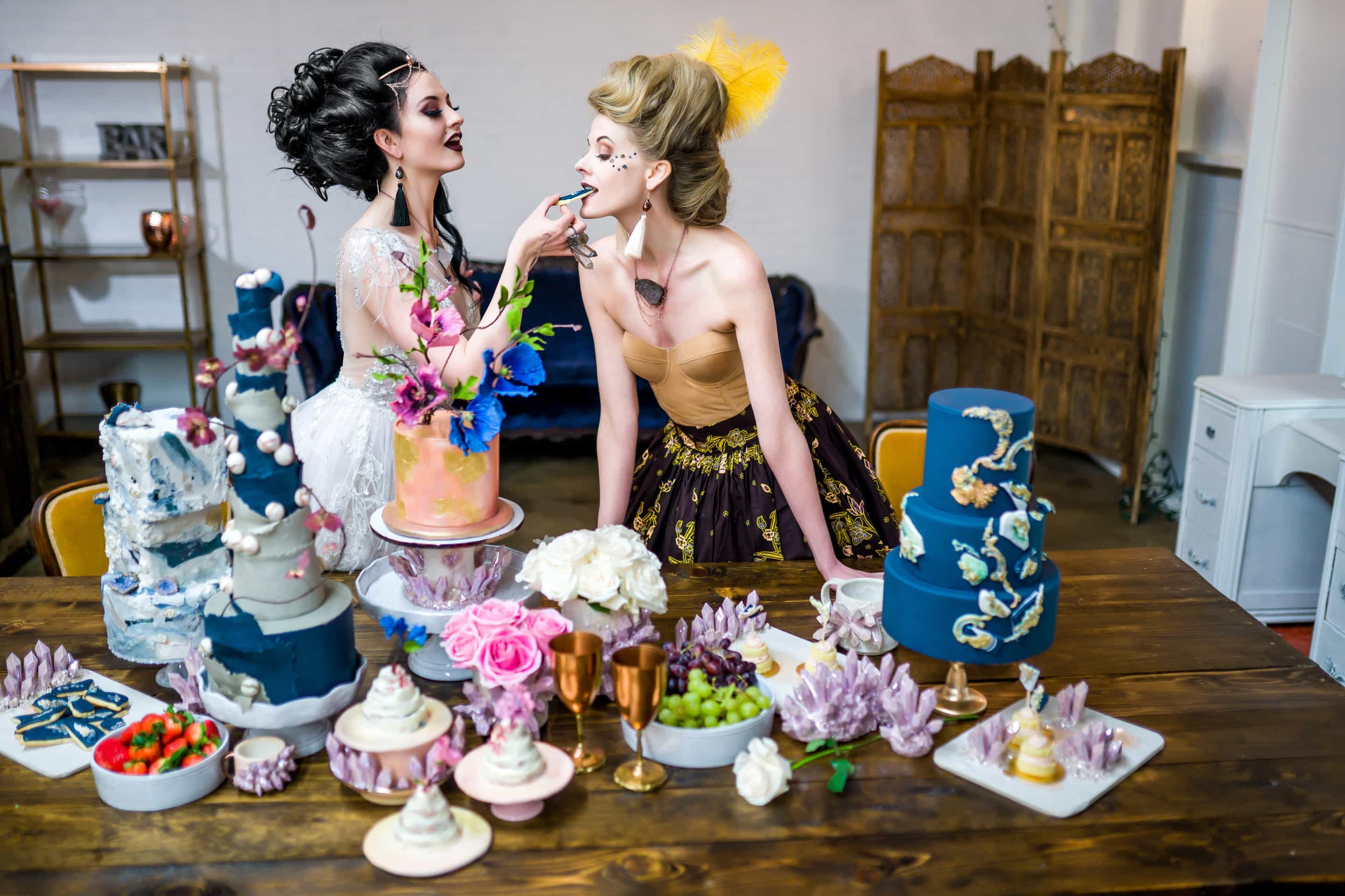 Models eating cake and wearing Desert Daisy Jewelry from the Marie Collection