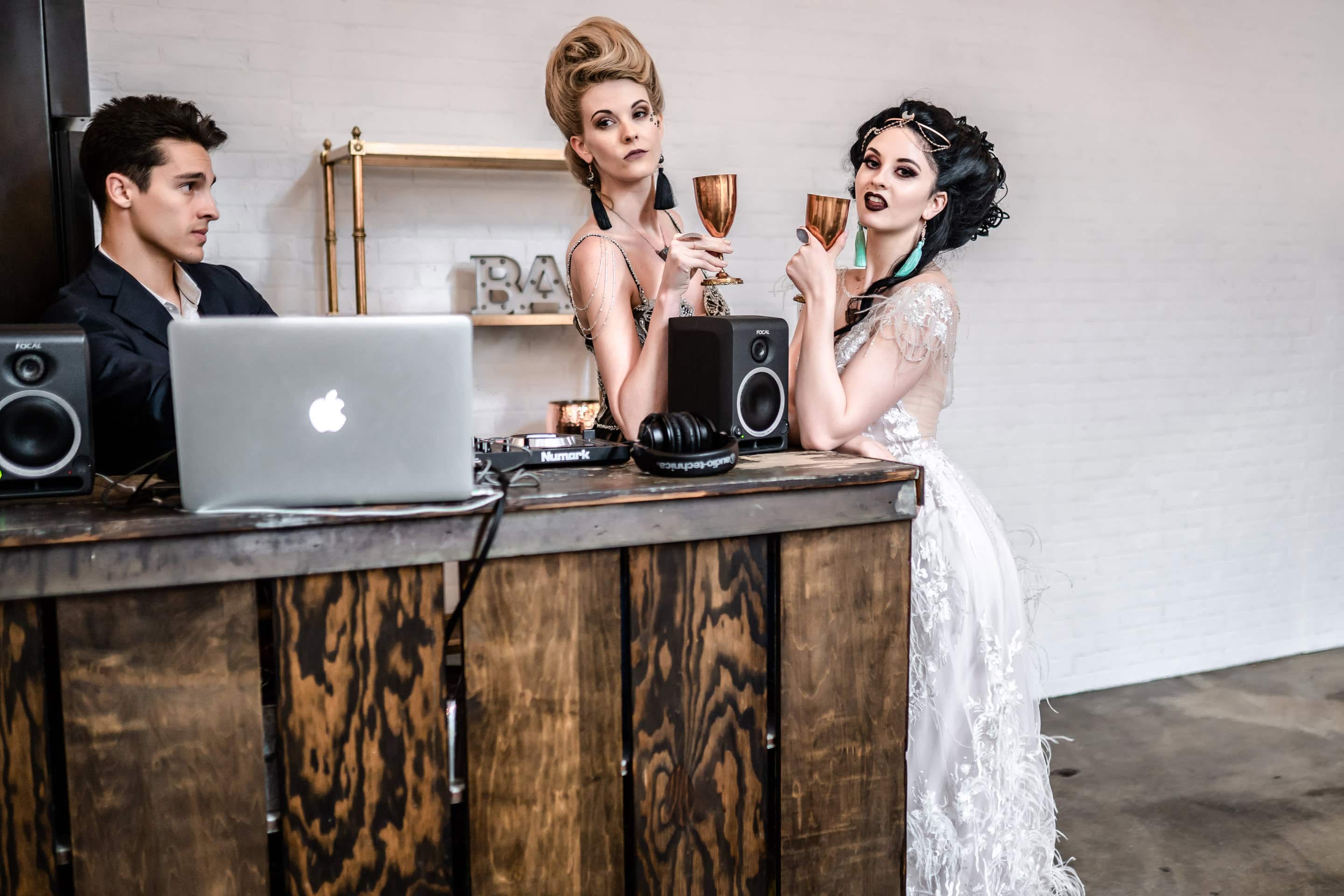 Models wearing Desert Daisy Jewelry and drinking wine